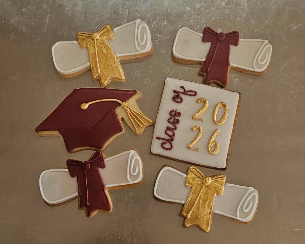 Hand-decorated graduation cookies with caps, diplomas, and Class of 2026 design