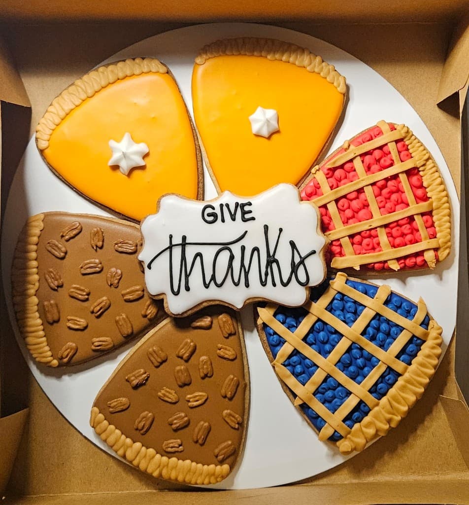 Decorated Thanksgiving pie-slice cookies surrounding a Give thanks cookie